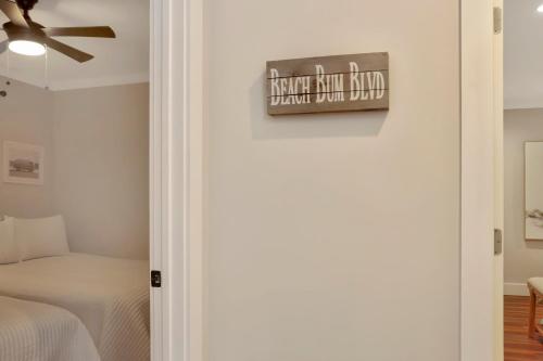 a bedroom with a bed and a sign on the wall at The Surf Ranch by Pristine Properties Vacation Rentals in Port Saint Joe