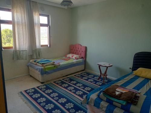 a bedroom with two twin beds and a table at ESKA 121 airport in Dalaman