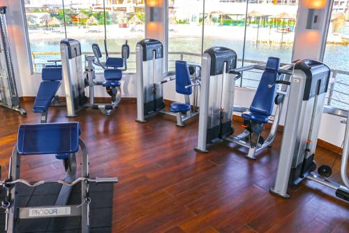 a gym with a row of treadmills and chairs at Lagoona Beach Luxury Resort and Spa in Manama