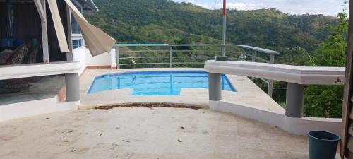 a swimming pool on the balcony of a house at Villa José al in Santiago de los Caballeros