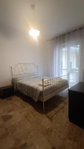 a bedroom with a bed in a room with a window at Battisti in Pavia