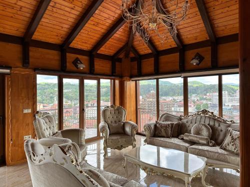 a living room with couches and chairs and a chandelier at Lux Villa Emina in Tuzla