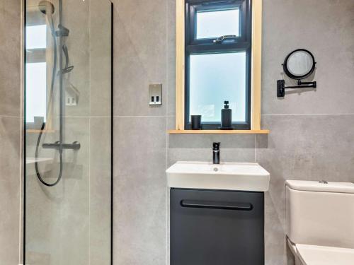 a bathroom with a sink and a shower at 3 Bed in Cullompton 94139 in Cullompton