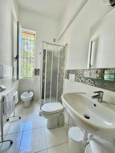 a bathroom with a sink and a toilet and a shower at Hotel Beau Rivage in Alassio