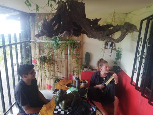 two men sitting at a table in a room at Terracota Mirador Filandia in Filandia