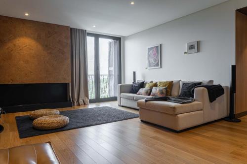 a living room with a couch and a tv at Pena Park Hotel in Ribeira de Pena