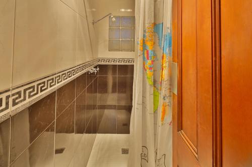 a bathroom with a shower with a shower curtain at Astor Private Hotel in Hobart
