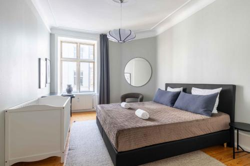 a bedroom with a large bed and a mirror at NEW charming apt in City Center in Copenhagen
