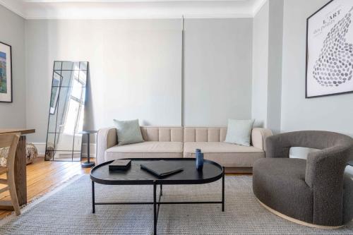 a living room with a couch and a coffee table at NEW charming apt in City Center in Copenhagen
