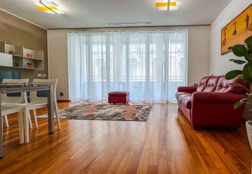 a living room with a couch and a table at Modern Luxury Loft Porta Nuova - Parcheggio Privato in Turin