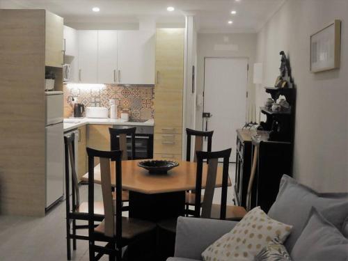 a kitchen and a table and chairs in a kitchen at Lagos Love Bay - sea view in Lagos