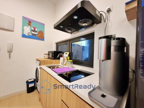 a kitchen with a coffee maker on the counter at Sunway GRID by SR Home in Kampong Pendas