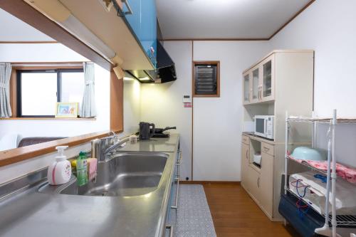 a kitchen with a sink and a counter at 7House in Tokyo