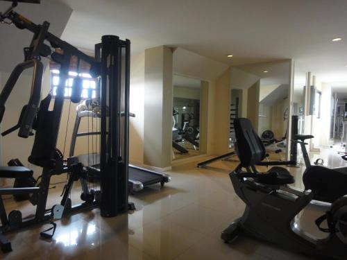 a gym with several tread machines in a room at Royal Place Banchang in Ban Chang