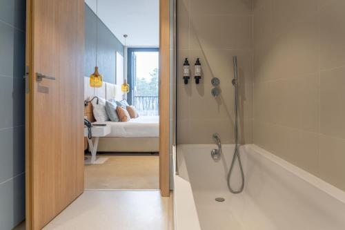 a bathroom with a shower and a bath tub at Pena Park Hotel in Ribeira de Pena