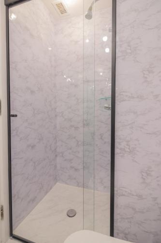 a shower with a glass door in a bathroom at The Capital Flat Itaim Bibi in Sao Paulo