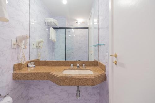 a bathroom with a sink and a shower at The Capital Flat Itaim Bibi in Sao Paulo