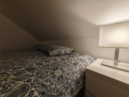 a bedroom with a bed and a lamp on a dresser at Pego CC in Pego