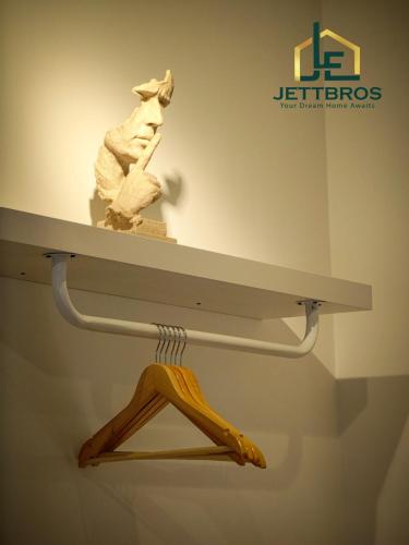a white shelf in a museum with a sculpture on it at Teega Residence By JettBros Iskandar Puteri in Nusajaya