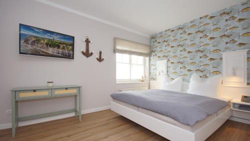 a bedroom with a bed with a fish wall at Haus Seeblick mit 9 Wohnungen in Alt Reddevitz
