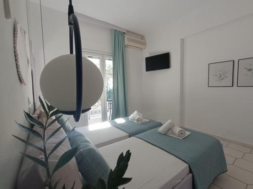 a white room with a bed and a mirror at Philippos Apartments in Acharavi