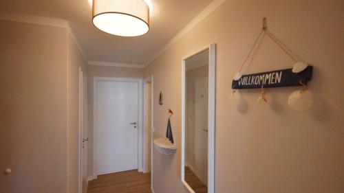a room with a hallway with a sign on the wall at Haus Seeblick mit 9 Wohnungen in Alt Reddevitz