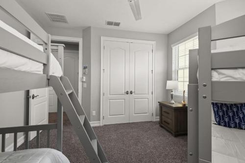 a bedroom with two bunk beds and a desk at Fortebello Beachside 154 in Indian Harbour Beach