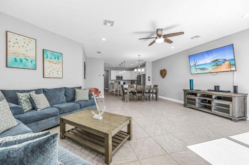 a living room with a blue couch and a table at Fortebello Beachside 170 With PRIVATE POOL in Indian Harbour Beach