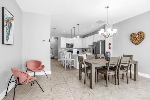 a kitchen and dining room with a table and chairs at Fortebello Beachside 170 With PRIVATE POOL in Indian Harbour Beach