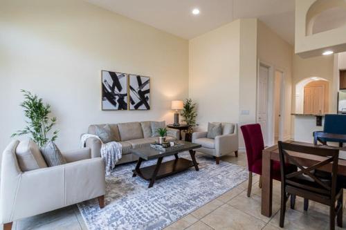 a living room with a couch and a table at Luxury Townhouse Minutes from Beach and Downtown in Indian Harbour Beach