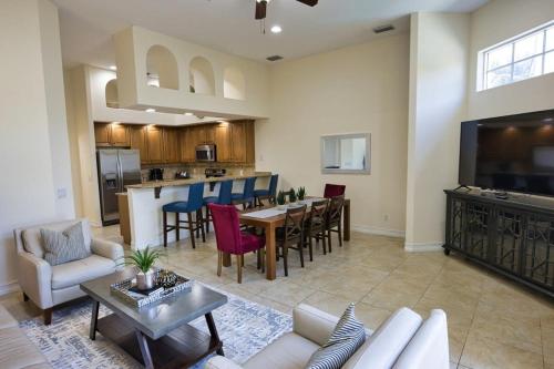 a living room with a couch and a table at Luxury Townhouse Minutes from Beach and Downtown in Indian Harbour Beach