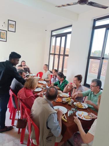 a group of people sitting at a table eating at hotel saanjh haveli in Orchha