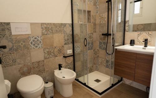 a bathroom with a shower and a toilet and a sink at Ballarò Room in Palermo