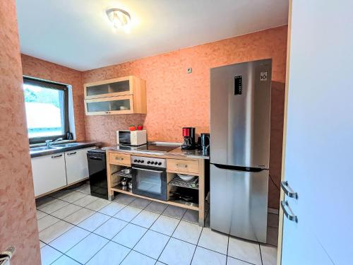 a kitchen with a stainless steel refrigerator at Apartment Ferienapartments Adenau-2 by Interhome in Adenau