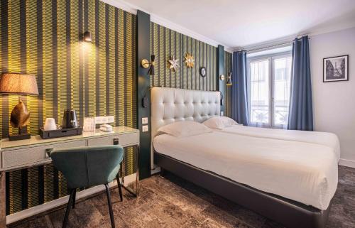 a bedroom with a bed and a desk and a chair at Hotel Marena in Paris