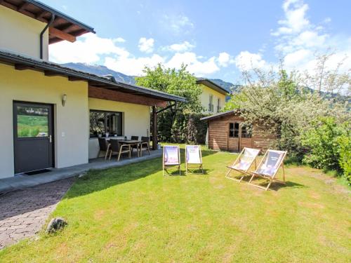 a group of chairs sitting in the yard of a house at Apartment Barbara-1 by Interhome in Fügen