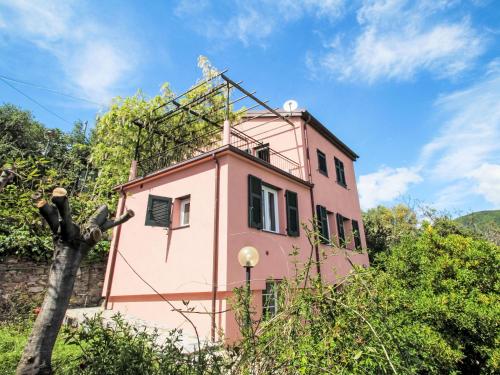 a pink building in the middle of trees at Holiday Home Italo by Interhome in Zoagli