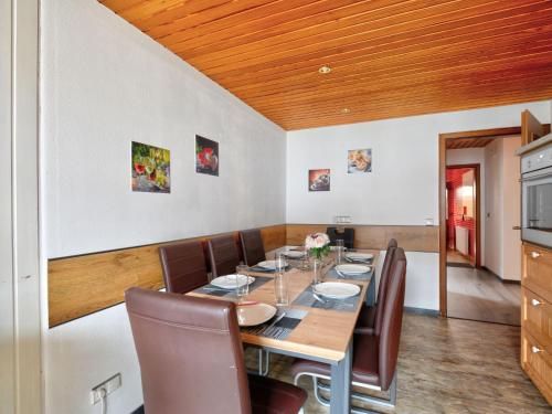 a dining room with a wooden table and chairs at Holiday Home Ferienhaus Born by Interhome in Schieder-Schwalenberg