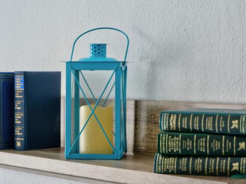a blue lantern sitting on a shelf with books at Holiday Home Ferienhaus Born by Interhome in Schieder-Schwalenberg