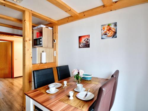 a dining room with a wooden table and chairs at Holiday Home Ferienhaus Born by Interhome in Schieder-Schwalenberg