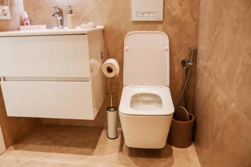 a bathroom with a white toilet and a sink at Kruja Townscape Rooms in Krujë