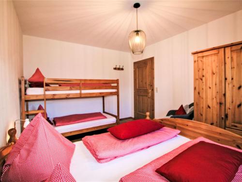 a bedroom with two bunk beds with red pillows at Apartment Christine by Interhome in Weerberg