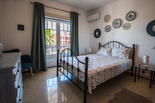 Schlafzimmer mit einem Bett und einem Fenster in der Unterkunft Charm Apartment T2 All With Big Terrace Albufeira Self check-in in Albufeira