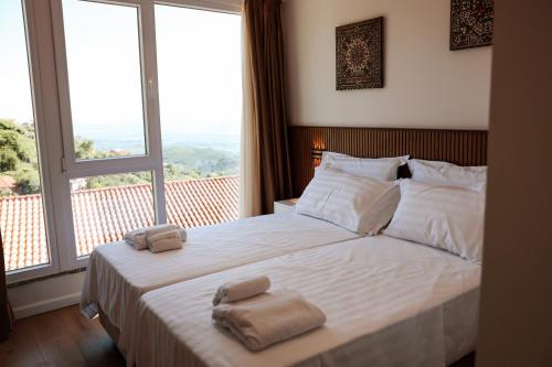 a bedroom with a bed with two towels on it at Kruja Townscape Rooms in Krujë