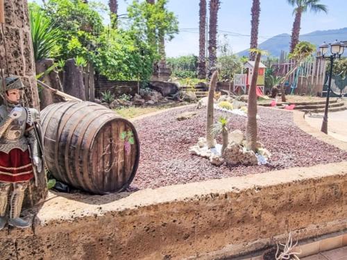 a wooden barrel sitting on a wall next to trees at Holiday Home Alice by Interhome in Ficarazzi