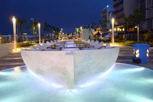 a long row of white tables in a parking lot at night at Luxury Home Ceccarini - Lungomare con parcheggio privato in Riccione