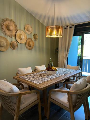 Un comedor con una mesa y algunas sillas. en Appartement de charme front de mer, en Saint-Paul
