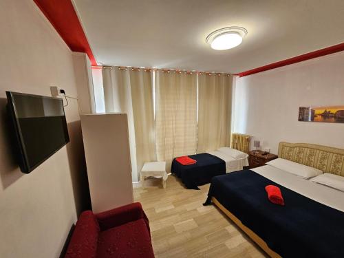 a hotel room with two beds and a tv at Venice Dream in Mestre