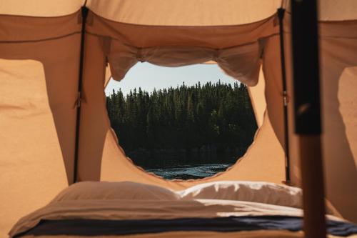a view from the inside of a tent with a window at Hôtel UNIQ - Forêt Ô Cascades in Rawdon