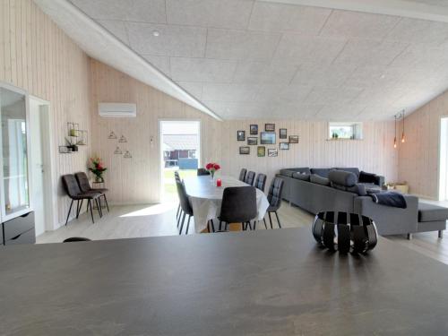 a living room with a table and a couch at Holiday Home Tahvo - 3-3km from the sea by Interhome in Rømø Kirkeby